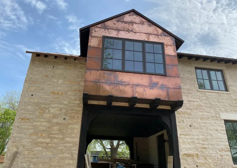 Copper metal panel facade on a stone building for Metal Roof Coating in Cave Spring